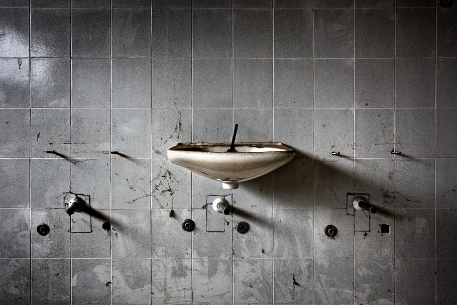 Tiled wall with sink. 
