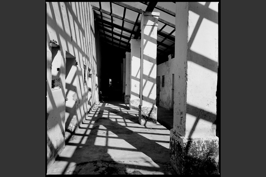 Shadows cast across a walkway of a former concentration camp