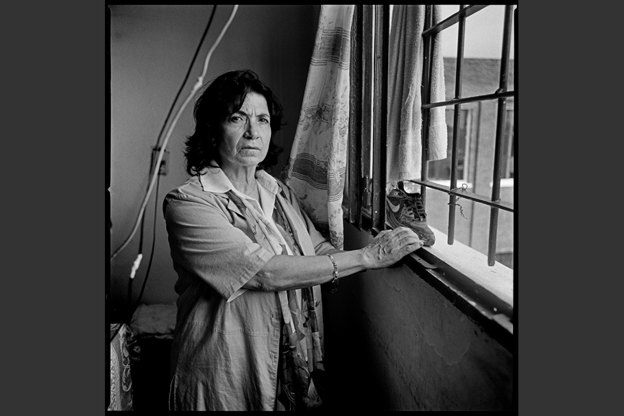 Portrait of a woman standing by a window