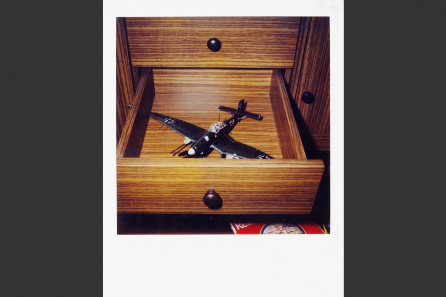 Open drawer with toy airplane