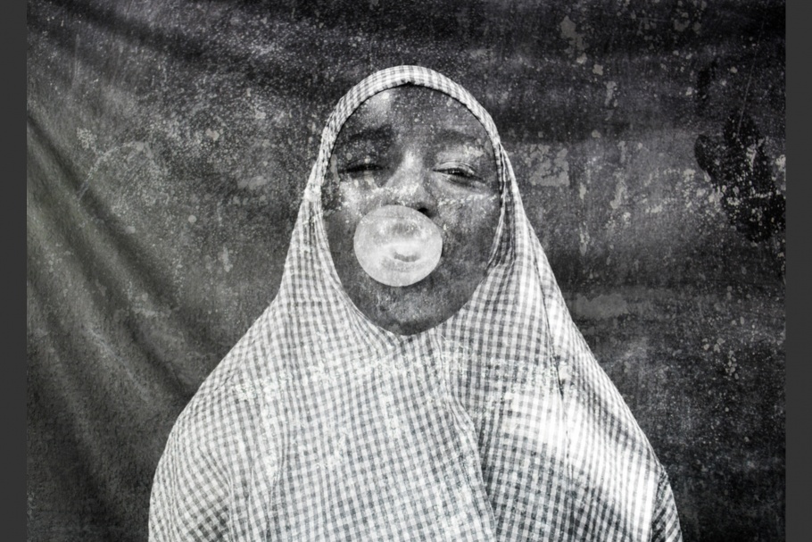 A woman blowing a gum bubble.