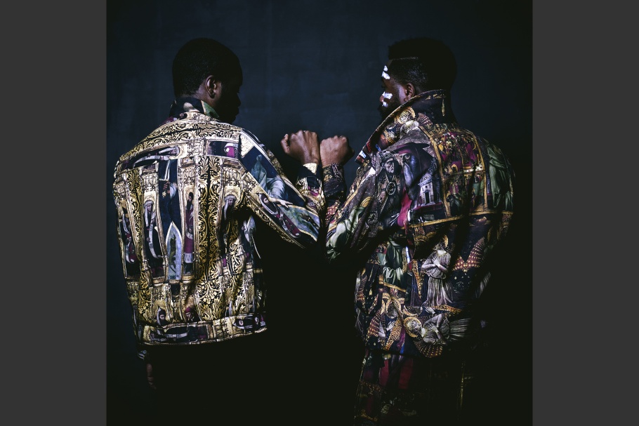 James Jean and Stephen Obisanya facing away with forearms touching