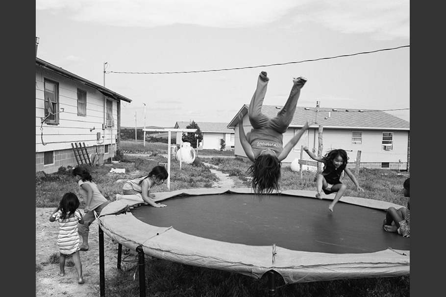 Kids playing on a trampoline.