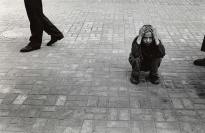 A boy crouching on the ground.