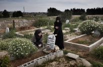 Two women at a grave.